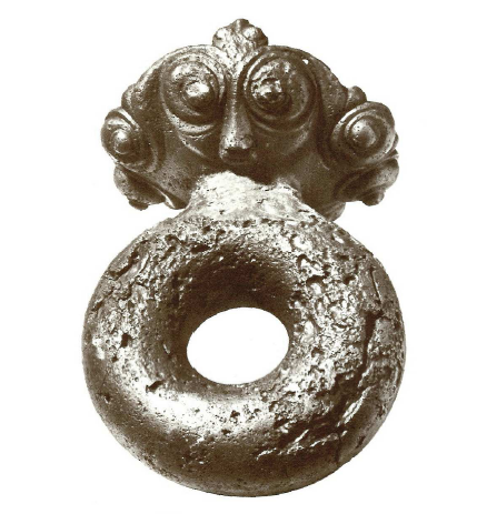 Fig. 2: A piece of cart with masks in bronze, dated 3rd c. BC, discovered in Mezek (Bulgaria). In Narodnija Archeologiceski Muzej, Sofia. Duval, 1977, pp. 28, 115.