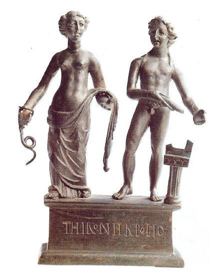 Fig. 61: Bronze group from Mâlain (Côte d’Or) of a goddess holding a snake and a god, identified as Thirona and Apollo by the inscription engraved on the socle.In Musée archéologique de Dijon. Deyts, 1998, p. 47, n°13.