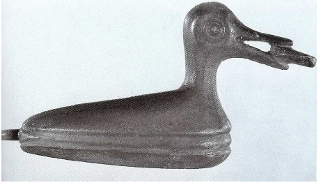 Fig. 13: Bronze duck with the demarcation of the water-line along its body, holding a pellet or a cake in its beak, discovered in the Iron Age Milber Down Fort (Devon). Green, 2004, plate 15, fig. 2.