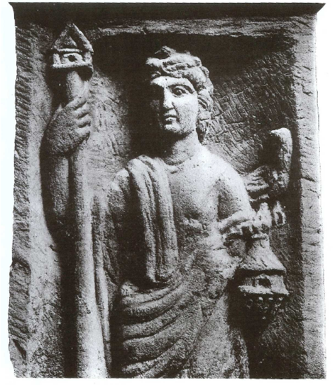 Fig. 7: Detail of the altar from Sarrebourg (Moselle) depicting Nantosuelta with her long staff-house attribute. A crow is perched on what seems to be a beehive or a cassolette for incense.